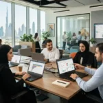 Sales professionals using CRM software to manage customer relationships in a UAE office